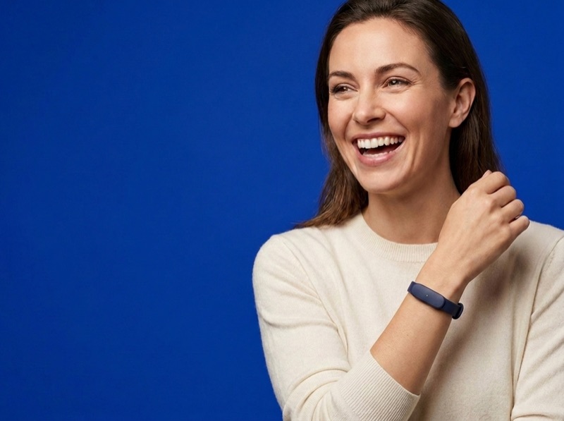 A woman laughing mid-conversation, wearing the slim navy Larkin wristband
