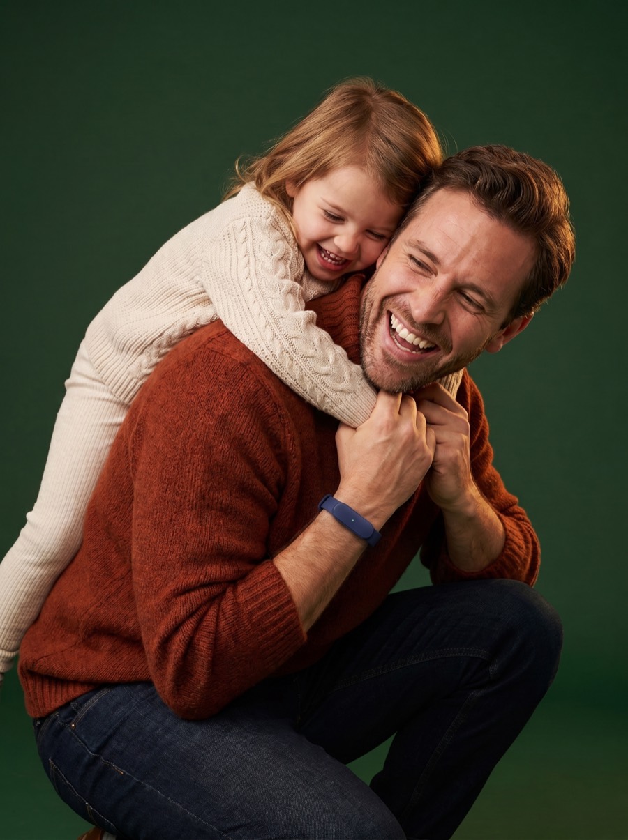 A father and daughter laughing together, the Larkin band on his wrist